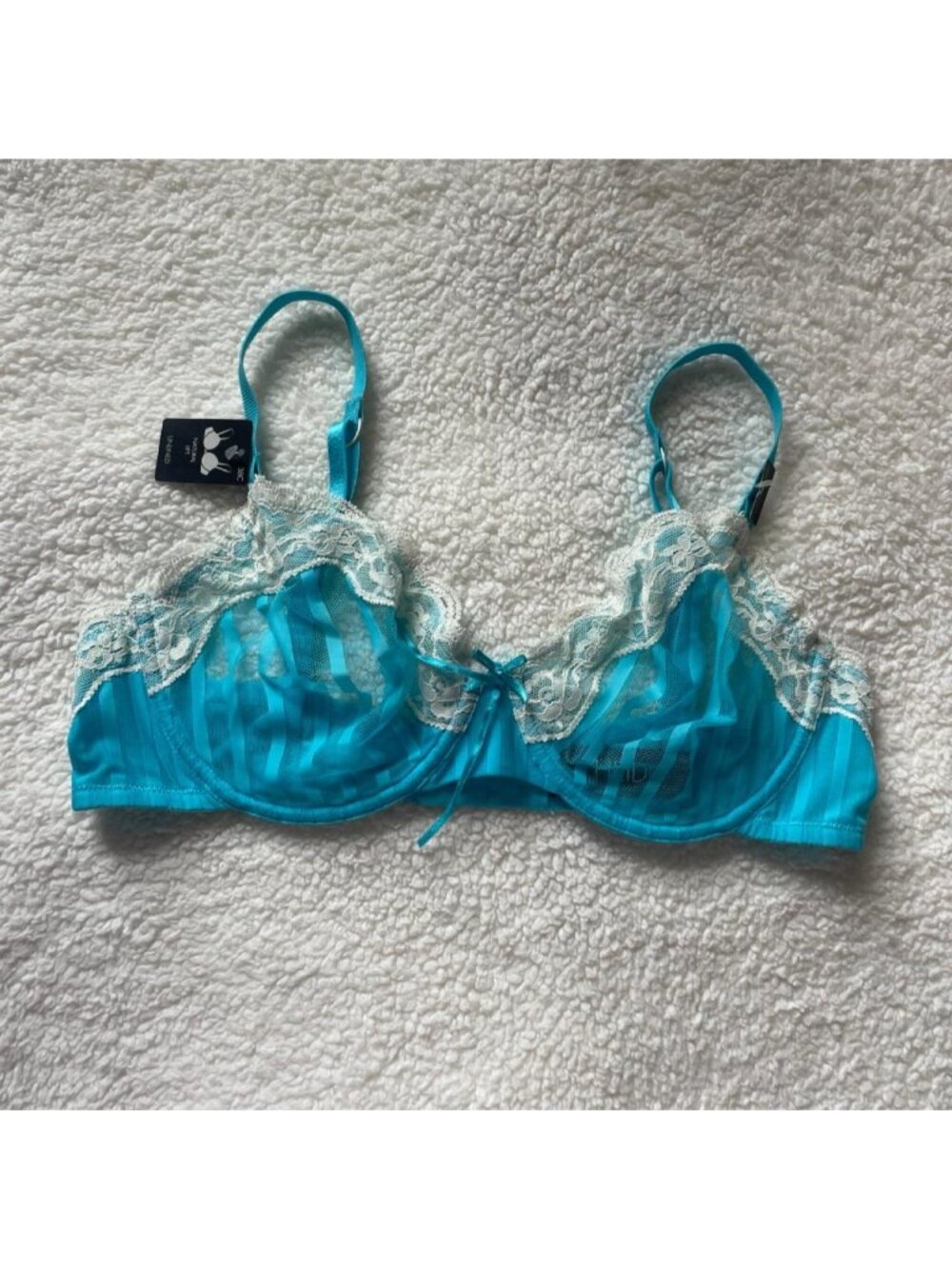 Blue lacy unlined bra with adjustable straps and bow detail